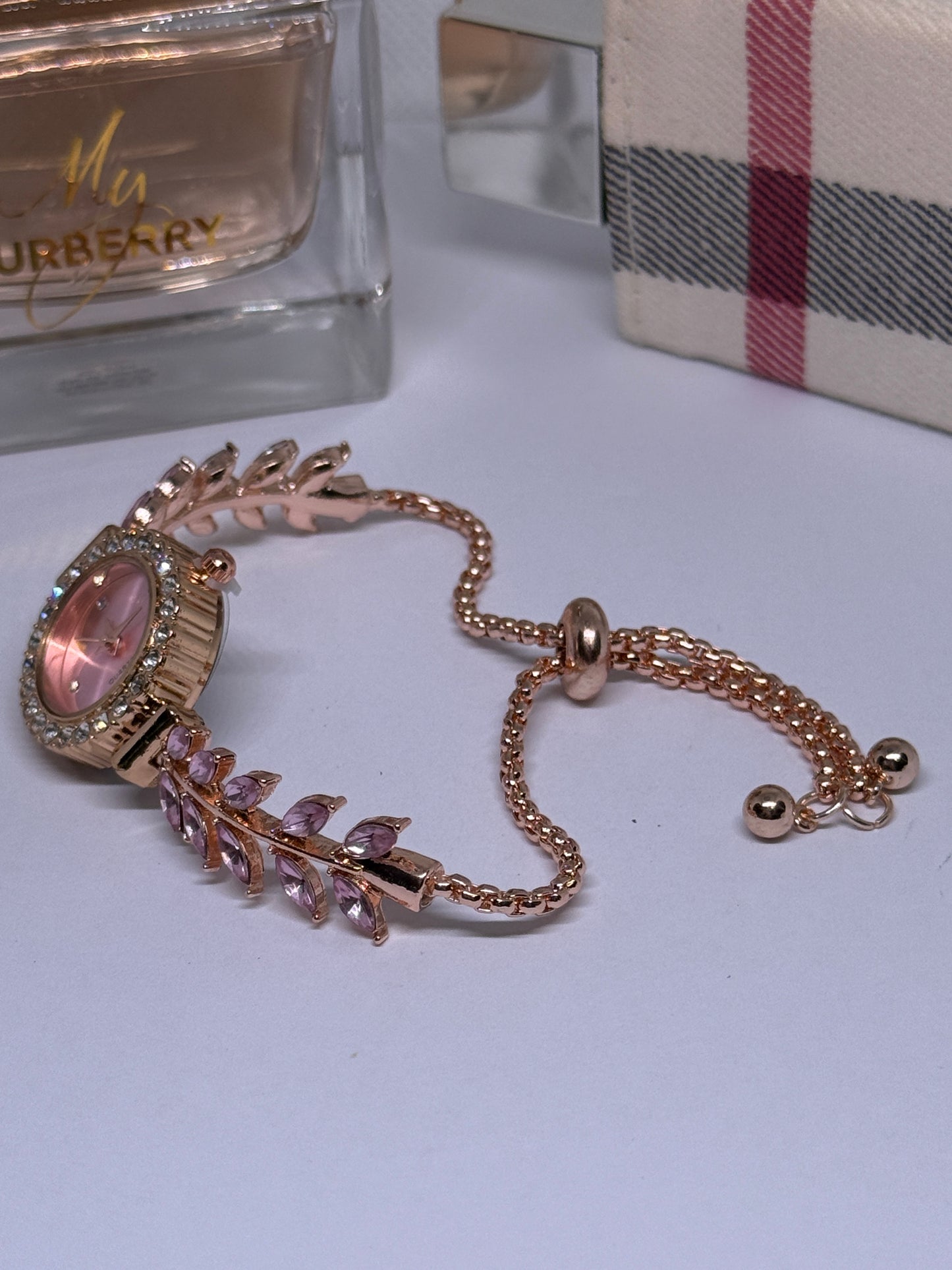 Golden bracelet watch with pink rhinestone