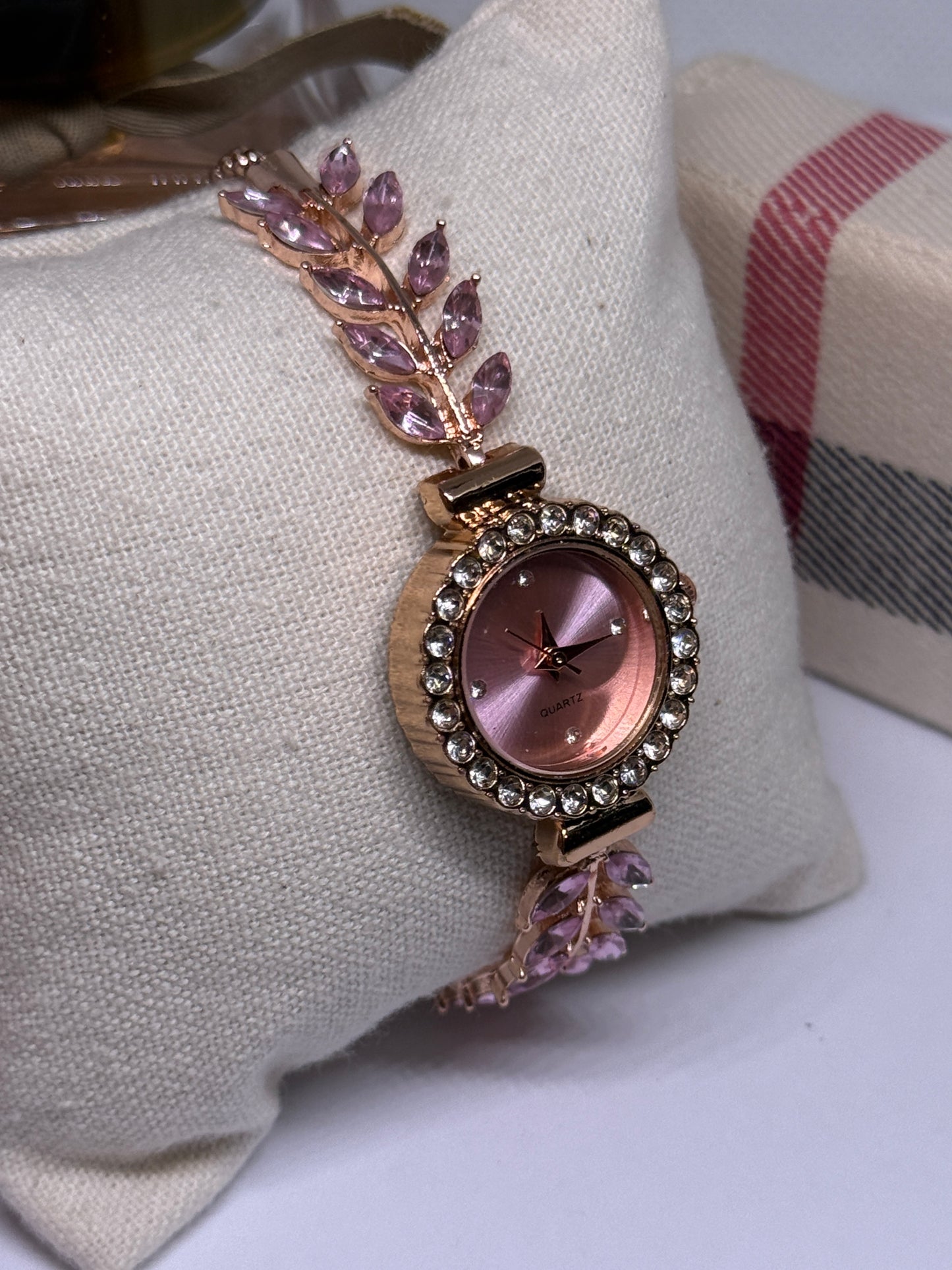 Golden bracelet watch with pink rhinestone