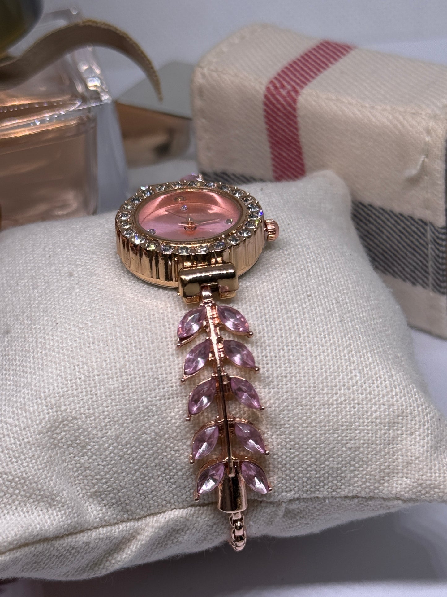Golden bracelet watch with pink rhinestone