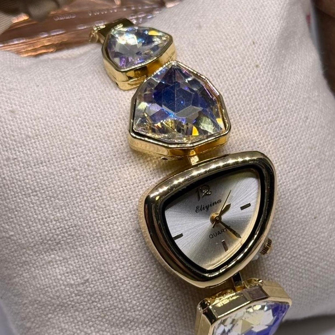 Gold tone crystal rhinestone watch with silver stone