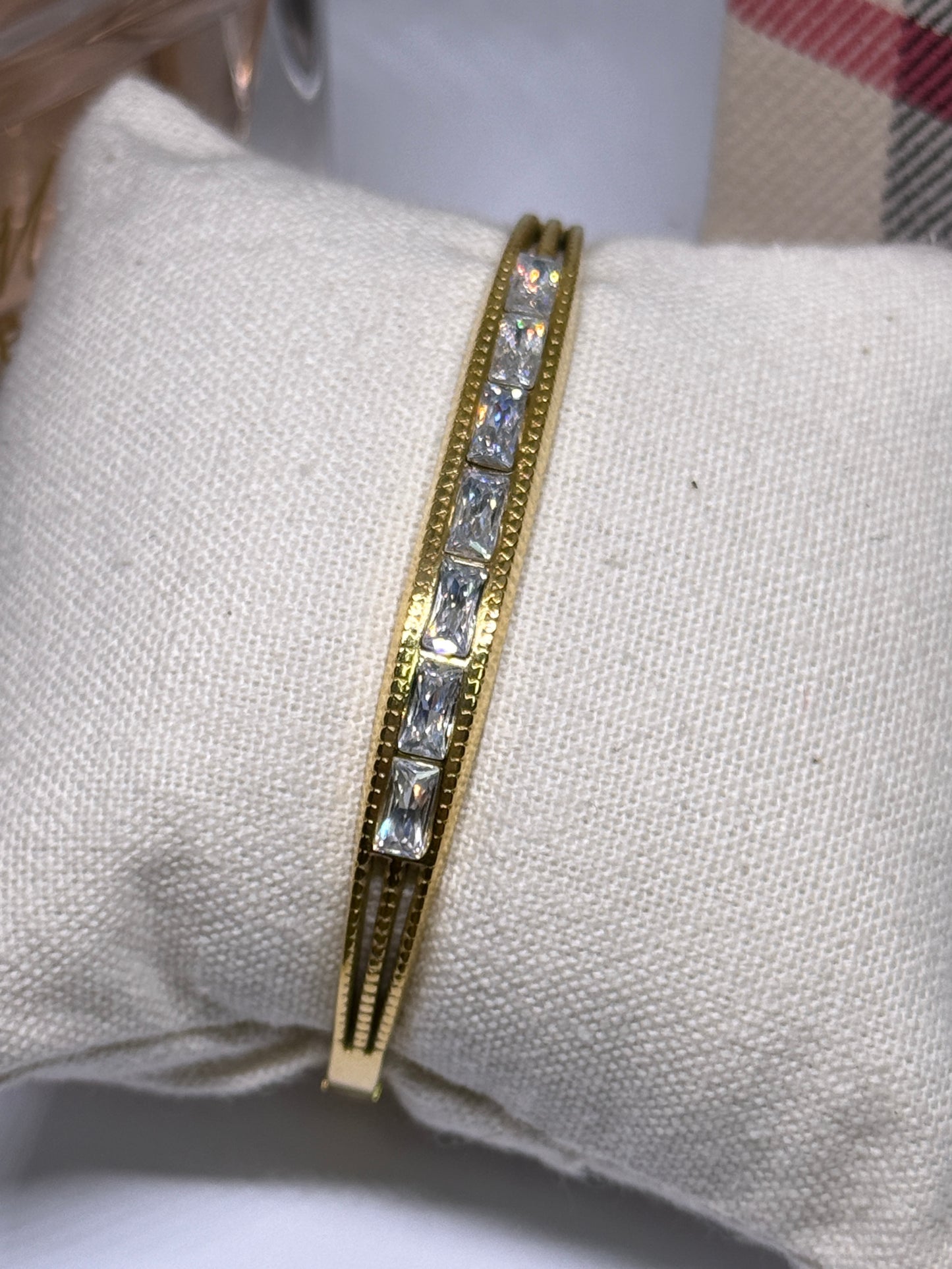 Gold bangle with glittering stone embossed