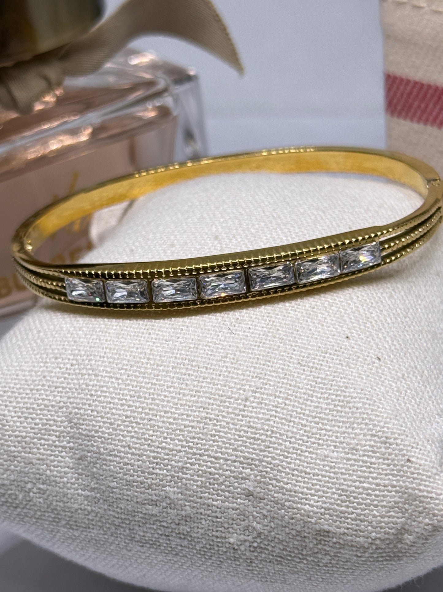 Gold bangle with glittering stone embossed
