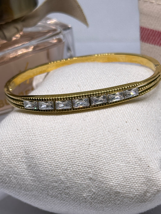 Gold bangle with glittering stone embossed