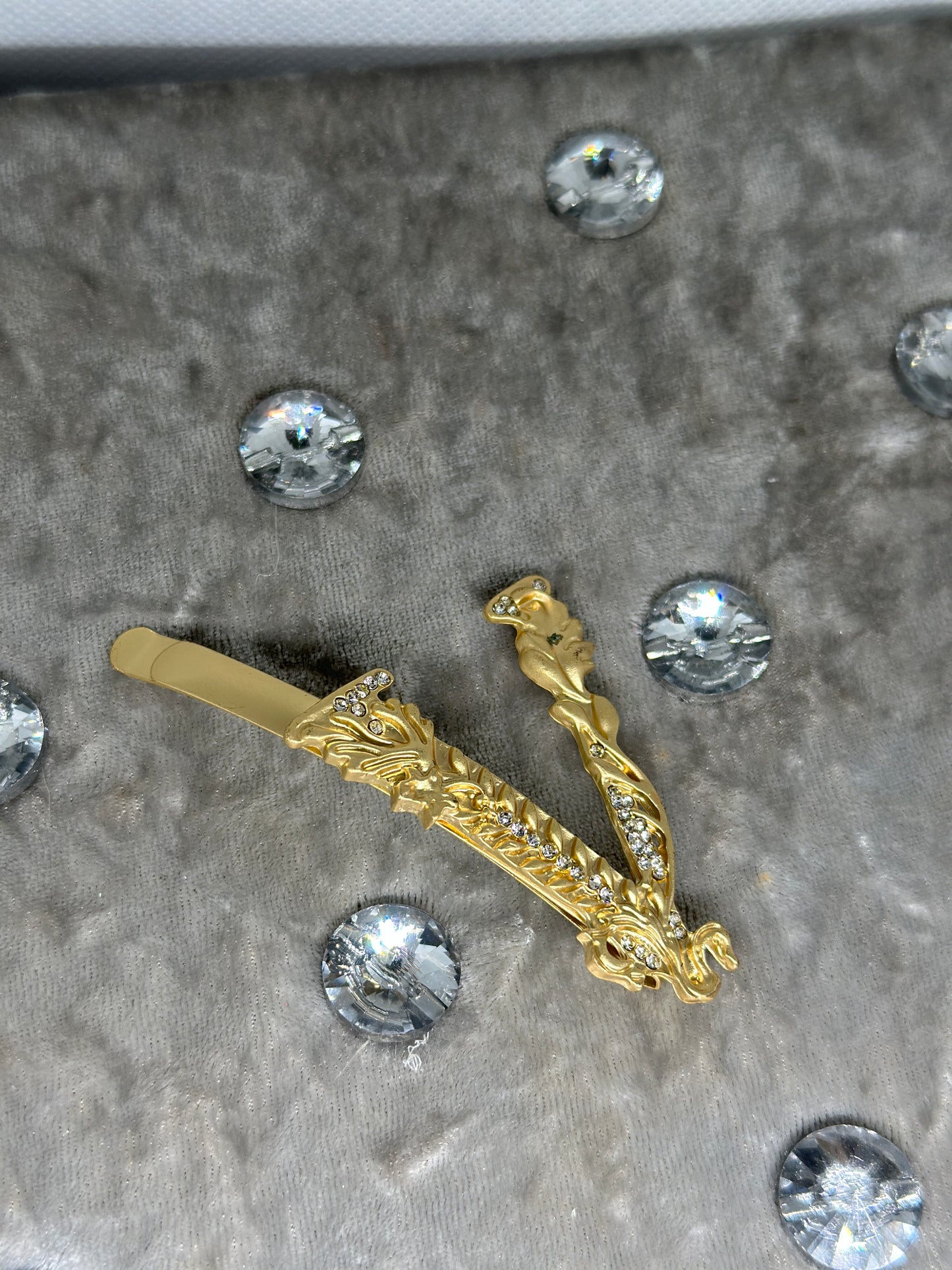 Golden rhinestone letter V clips