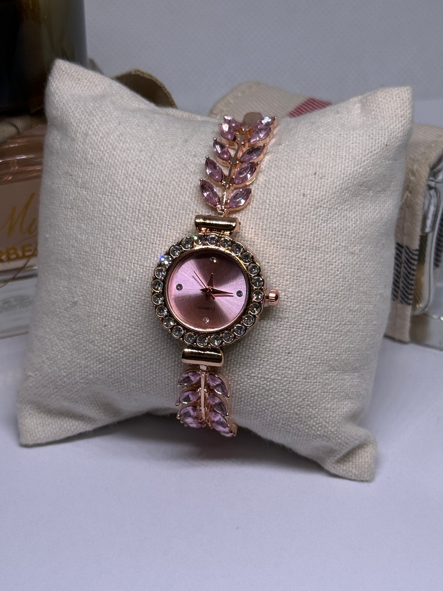 Golden bracelet watch with pink rhinestone