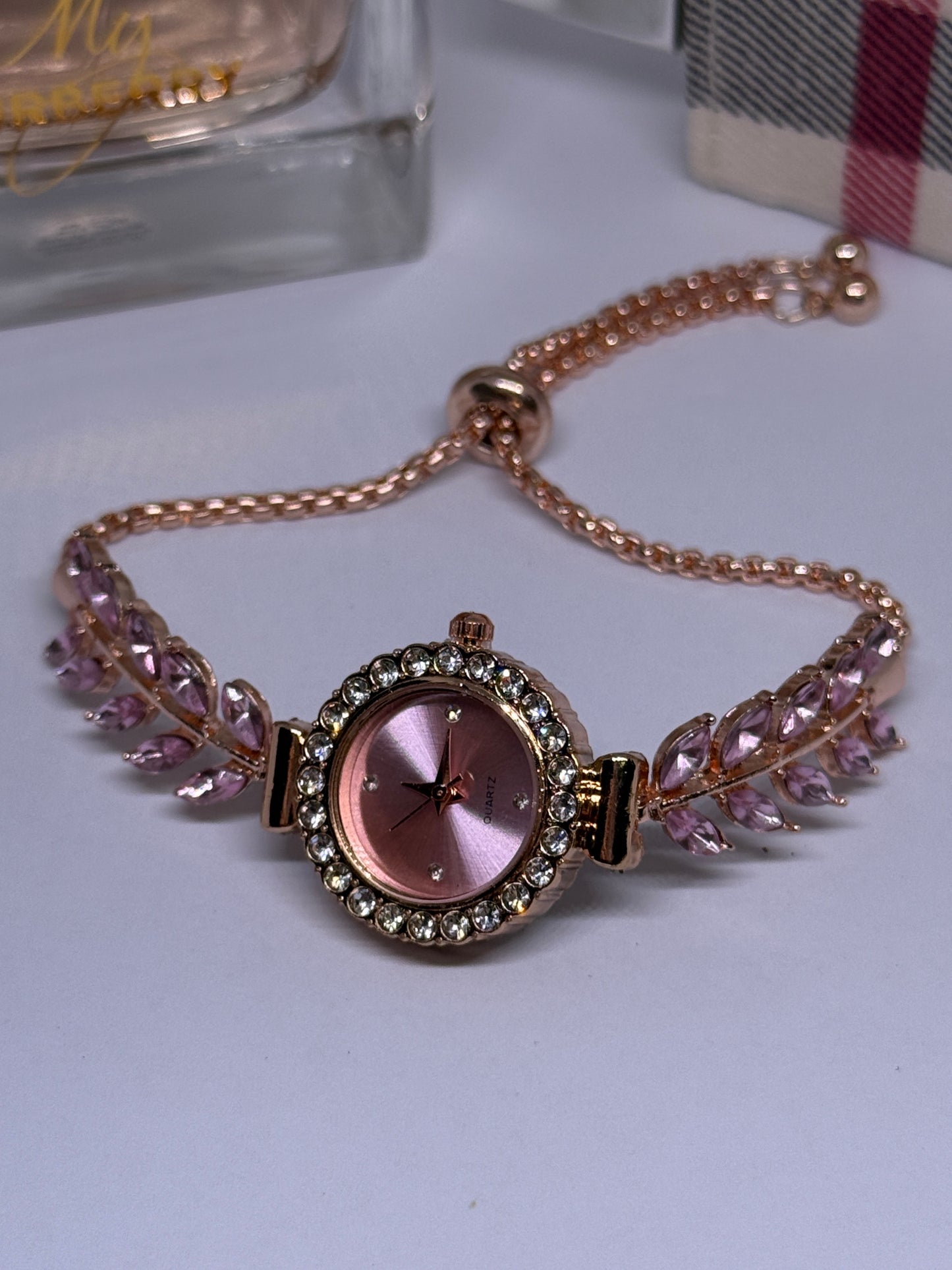 Golden bracelet watch with pink rhinestone